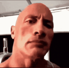 A spinning gif of a bald man raising one eyebrow